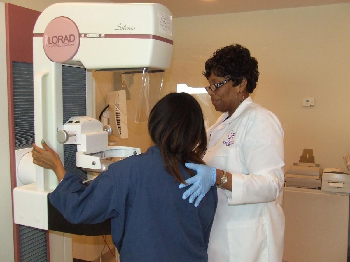 A woman is positioned for a mammogram