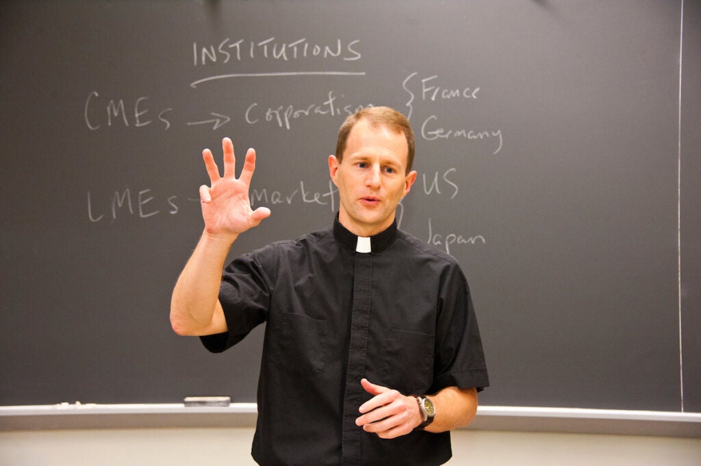 Jesuit professor teaching a class.