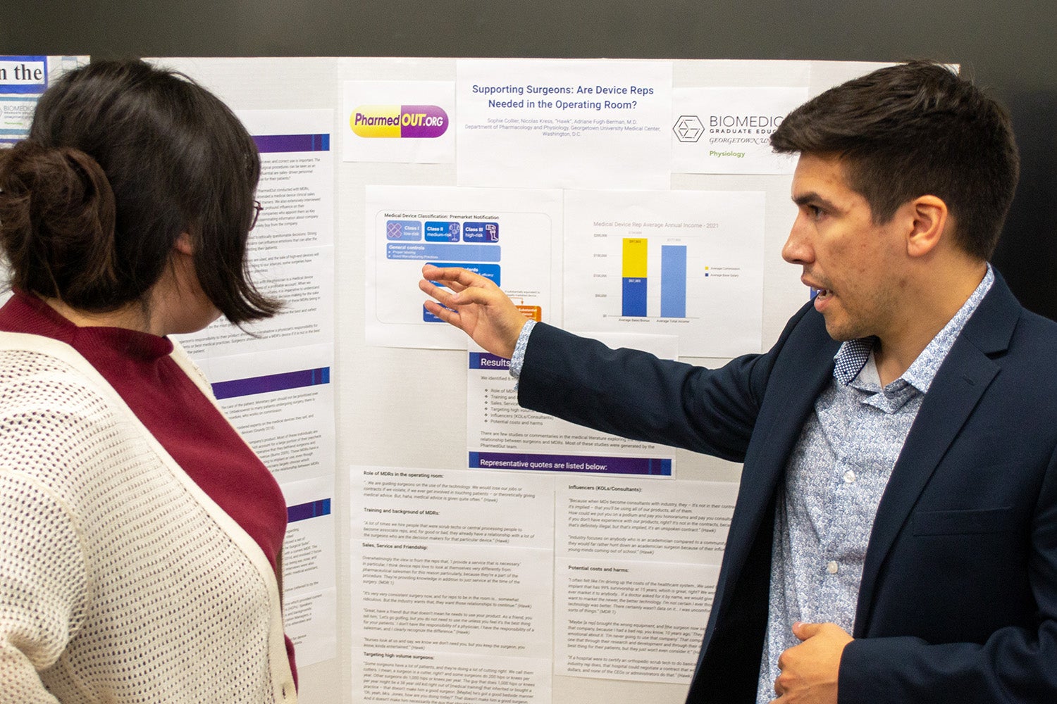 A student presents a poster during the Pharmacology & Physiology poster session