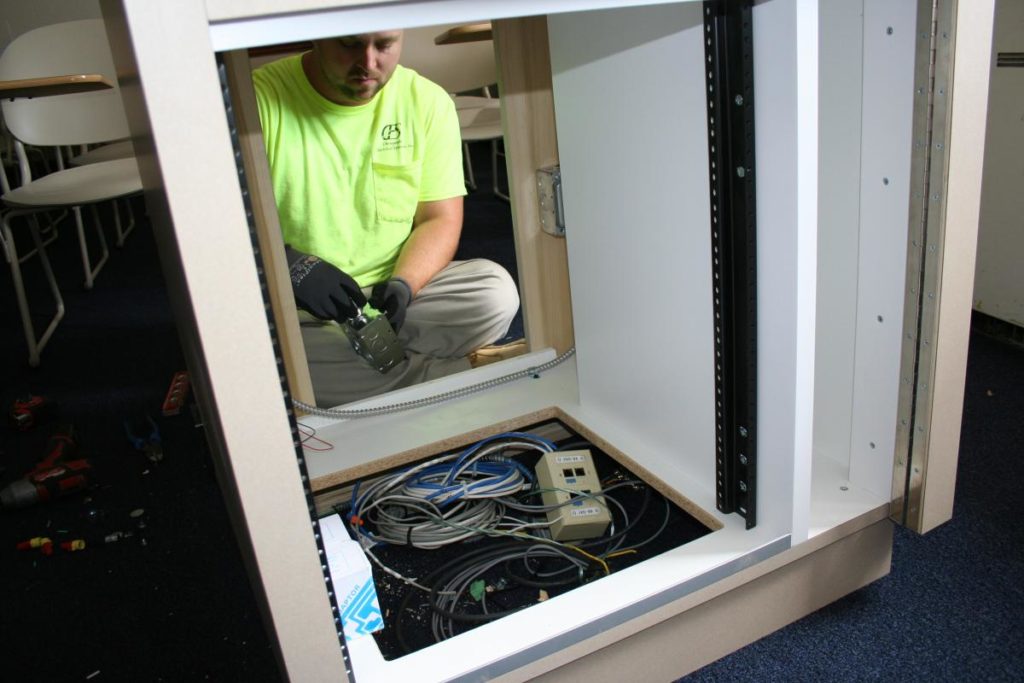 Contractor wiring new, smaller podium