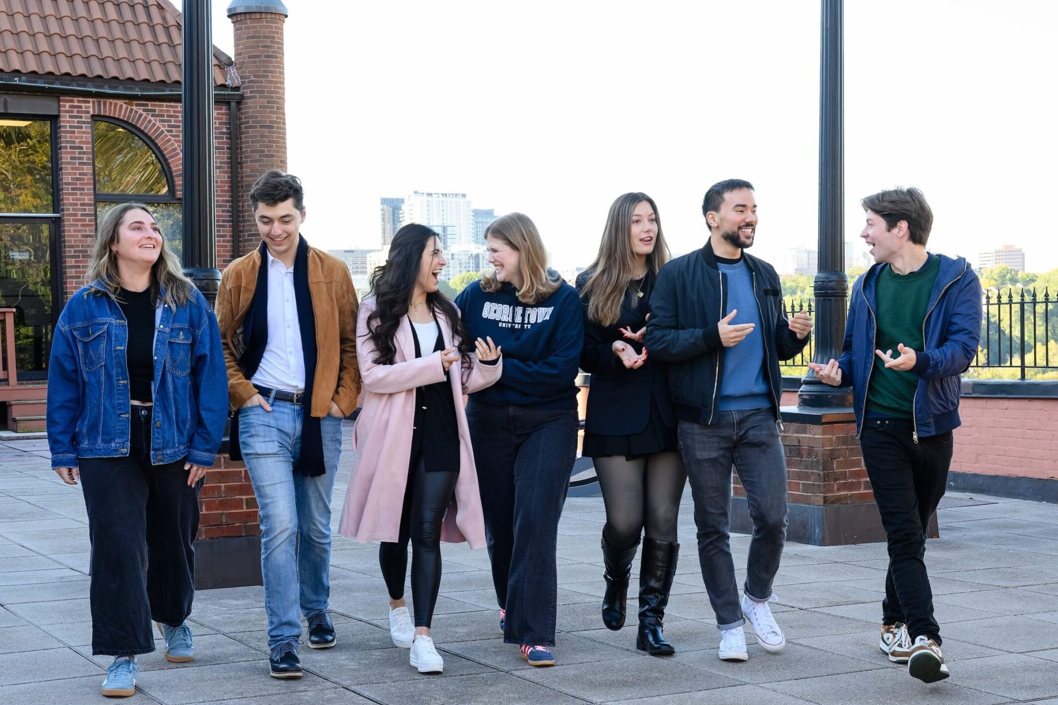 A group of Conflict Resolution students walking together and talking outside of the Car Barn.