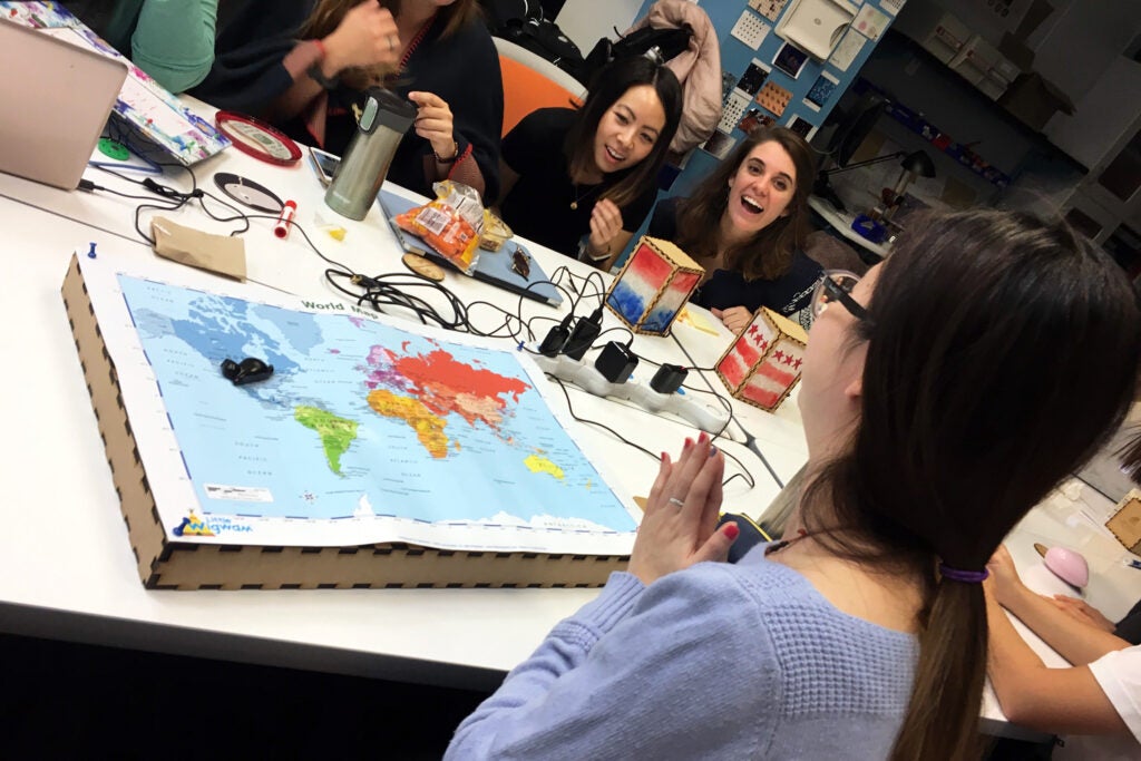 students around a table with supplies