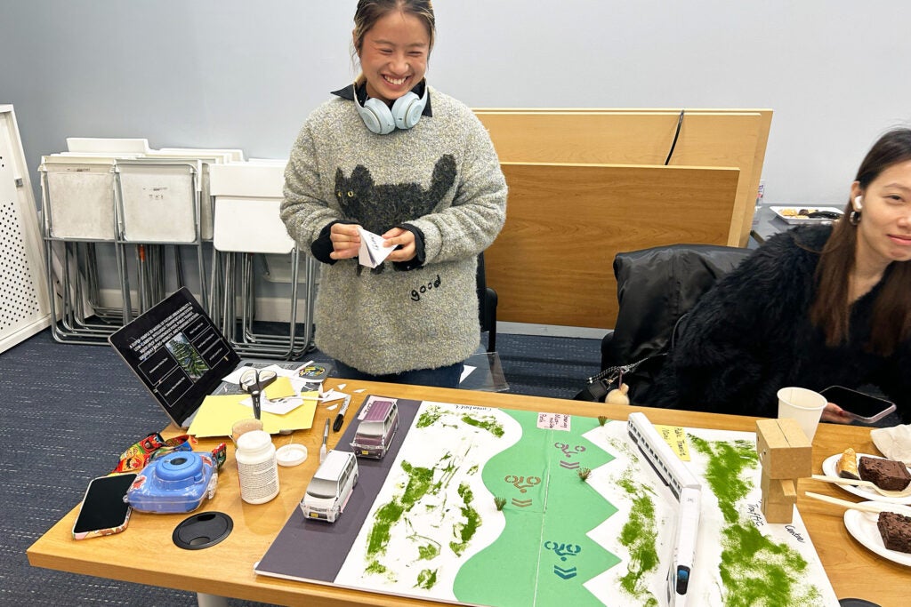 student in front of a project