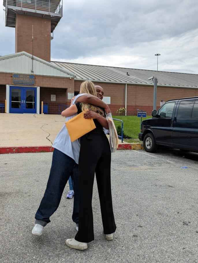 Tray Jones hugging Making an Exoneree student Frances Trousdale.