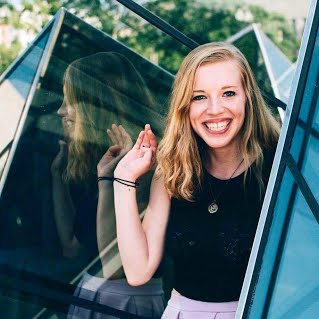 Lauren Stricker in front of glass structure