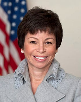 Headshot of Valerie Jarrett in front of the American flag.