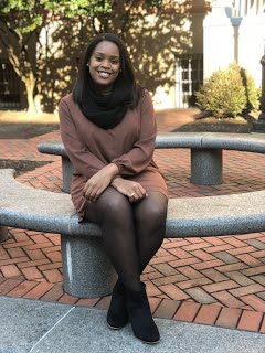 Shakera Vaughan sitting on a circular bench